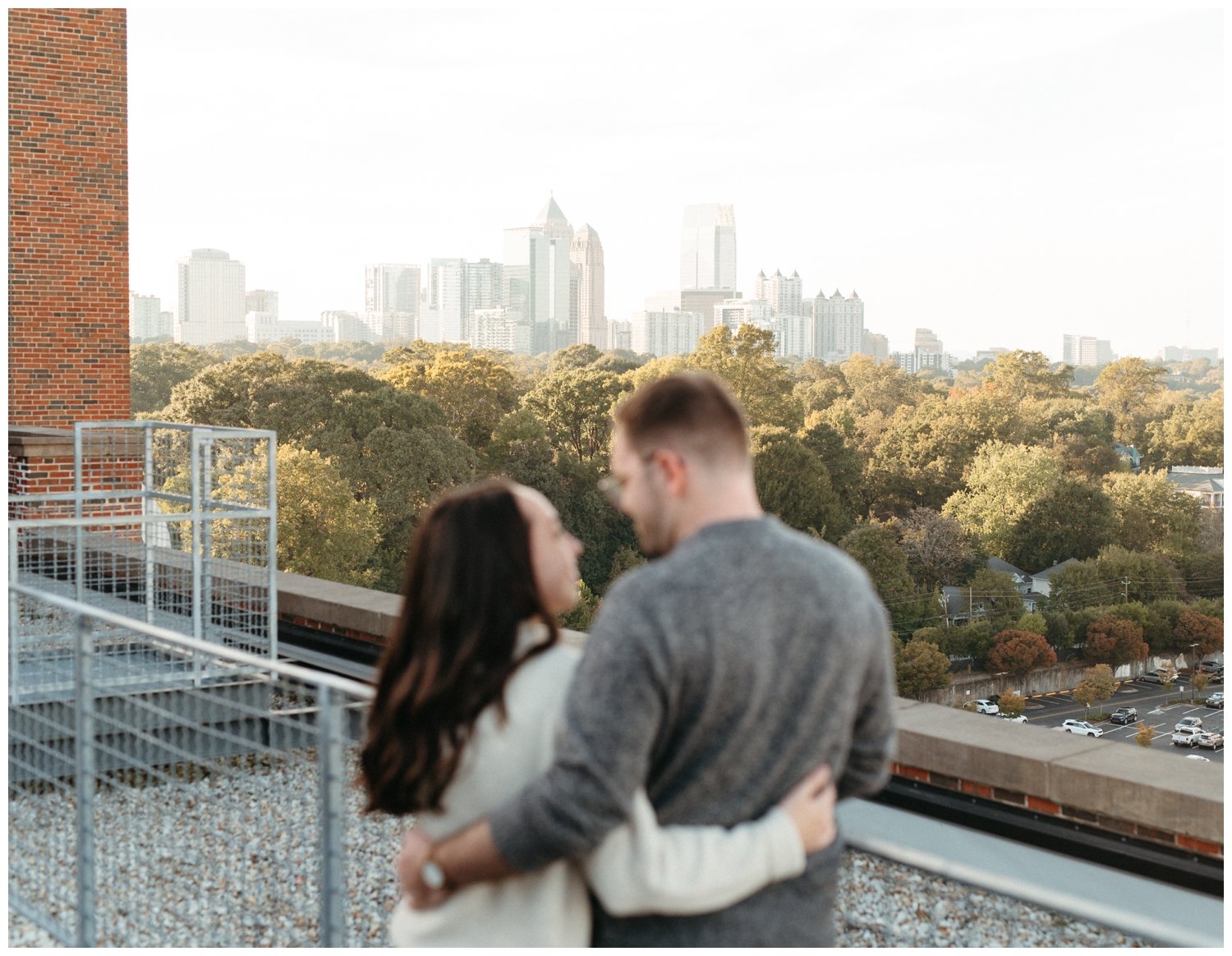 Couple in foreground of photo of skyline in Atlanta engagement photos