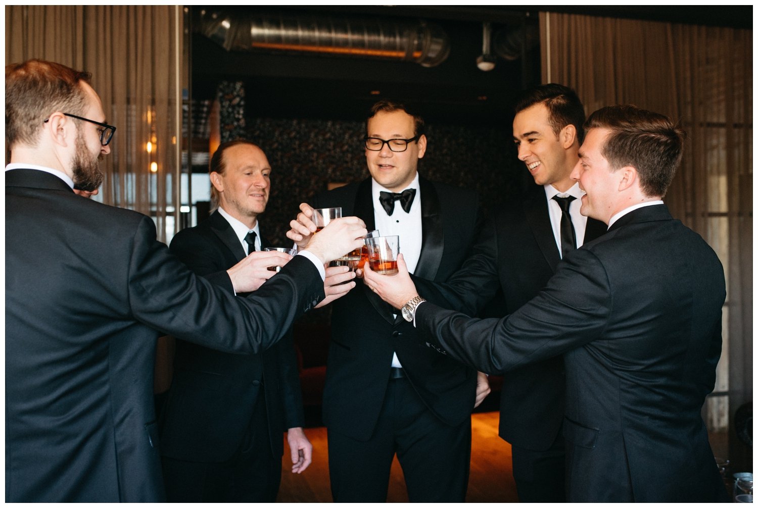 The groom and groomsmen toast scotch at the Ponce City Market wedding