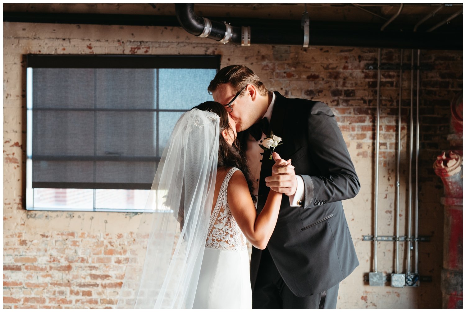 The couple kisses inside at Ponce City Market