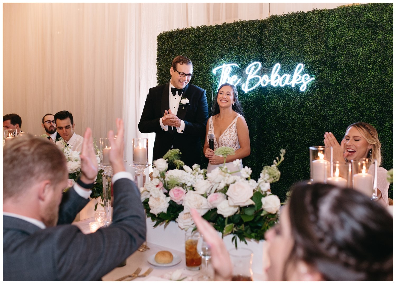 The bride and groom welcome guests to the Ponce City Market wedding reception