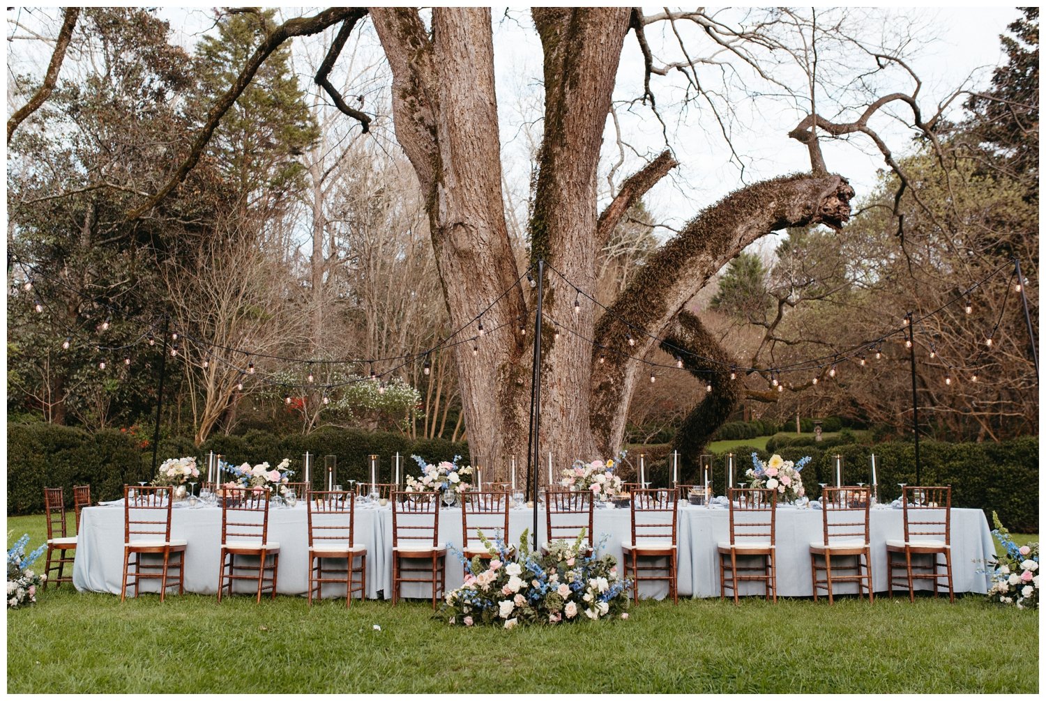 A table set for a wedding reception under a tree at an Atlanta intimate wedding venue