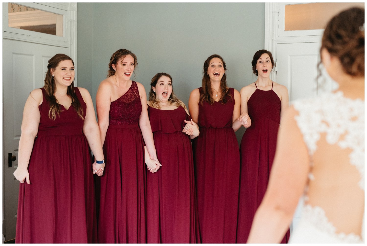 The bridesmaids react to the bride in her full wedding wear for the intimate destination wedding