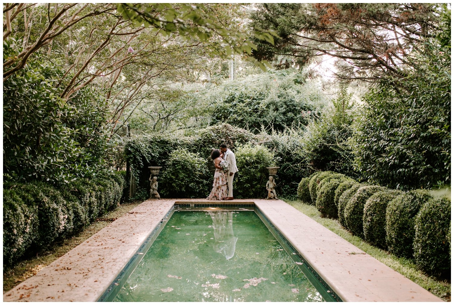 A couple stands by a reflecting pool at one of the luxury wedding venues in Atlanta